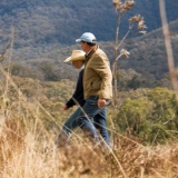 Thumbnail of two people walking in grassy land