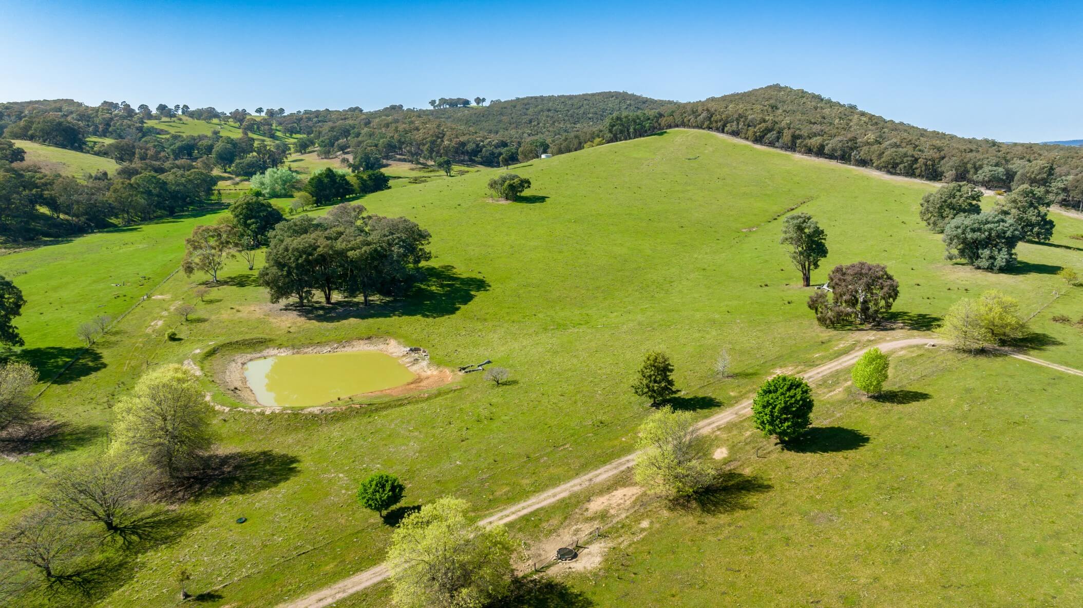 An aerial view of a dirt road on the property