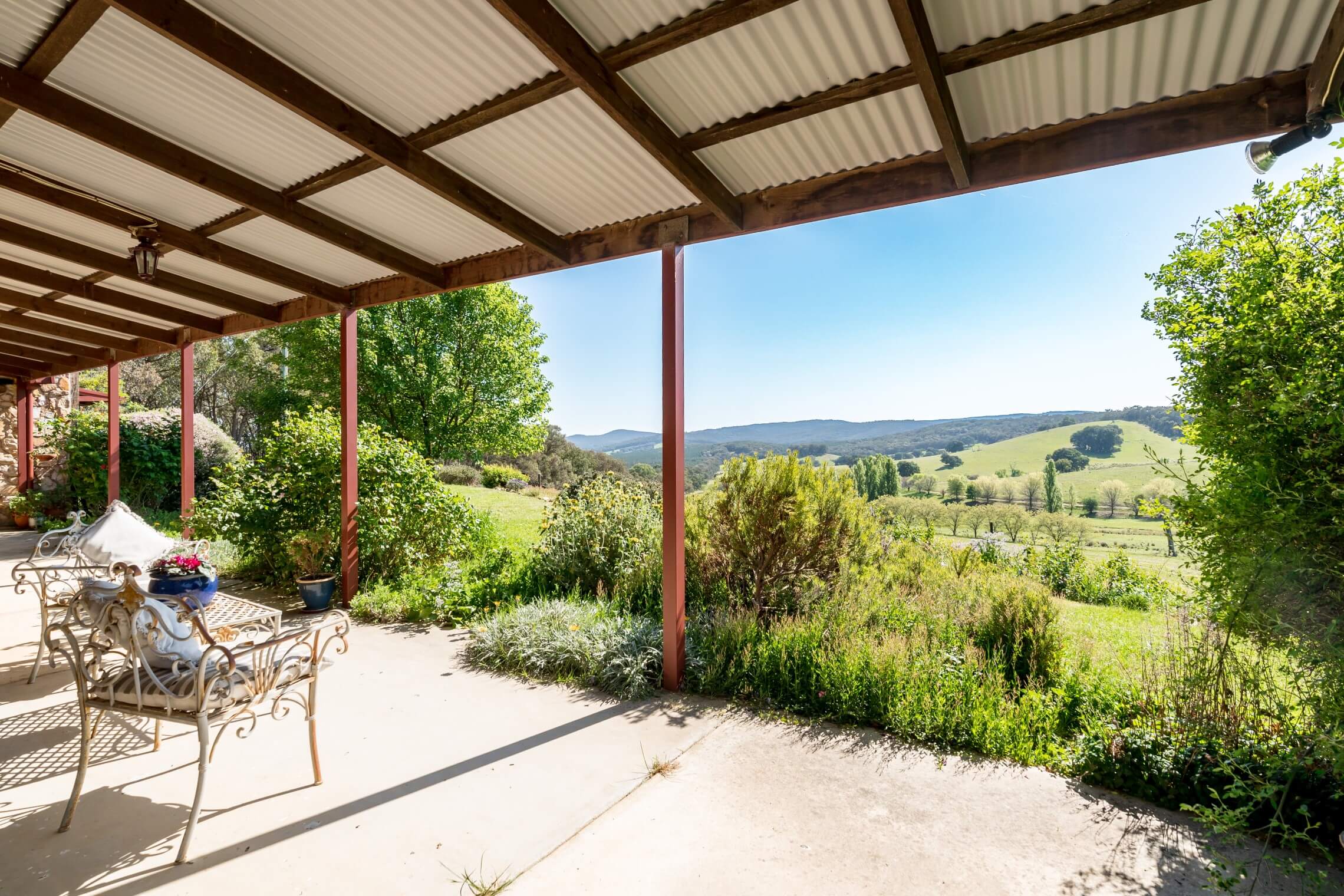 A photo under the property home patio looking out to the hills